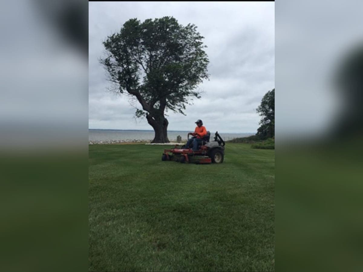 Zero-turn mower cutting a waterfront lawn on Maryland's Eastern Shore